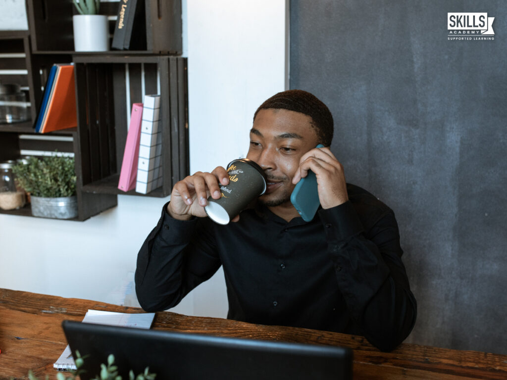 有人一边喝咖啡一边打电话。在南非哪里在线学习办公室管理。